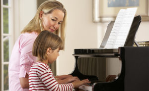 parent and child practicing piano