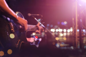 Guitarist on stage for background, soft and blur concept