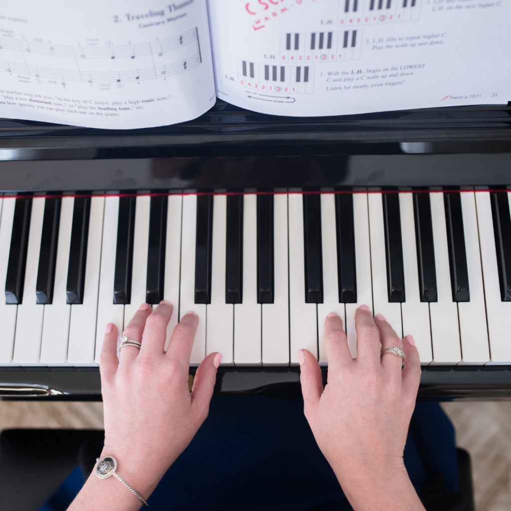 child's hands on the piano
