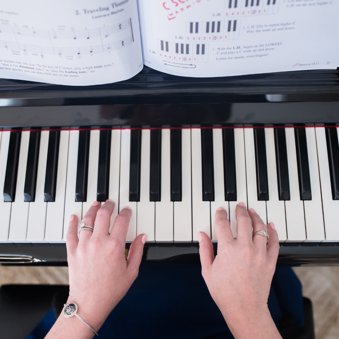 child's hands on the piano