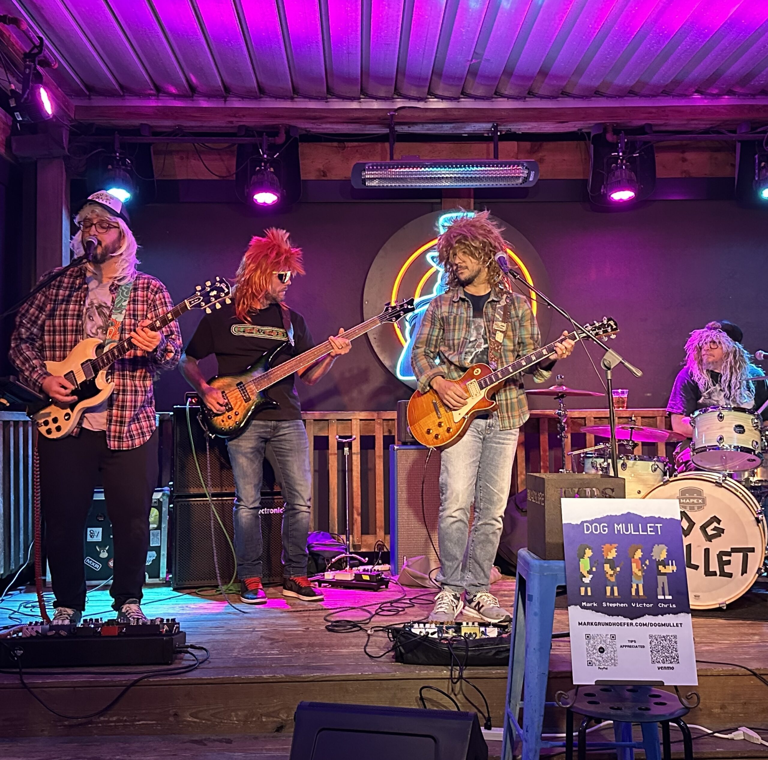 The four members of Dog Mullet performing on stage at Mad Life