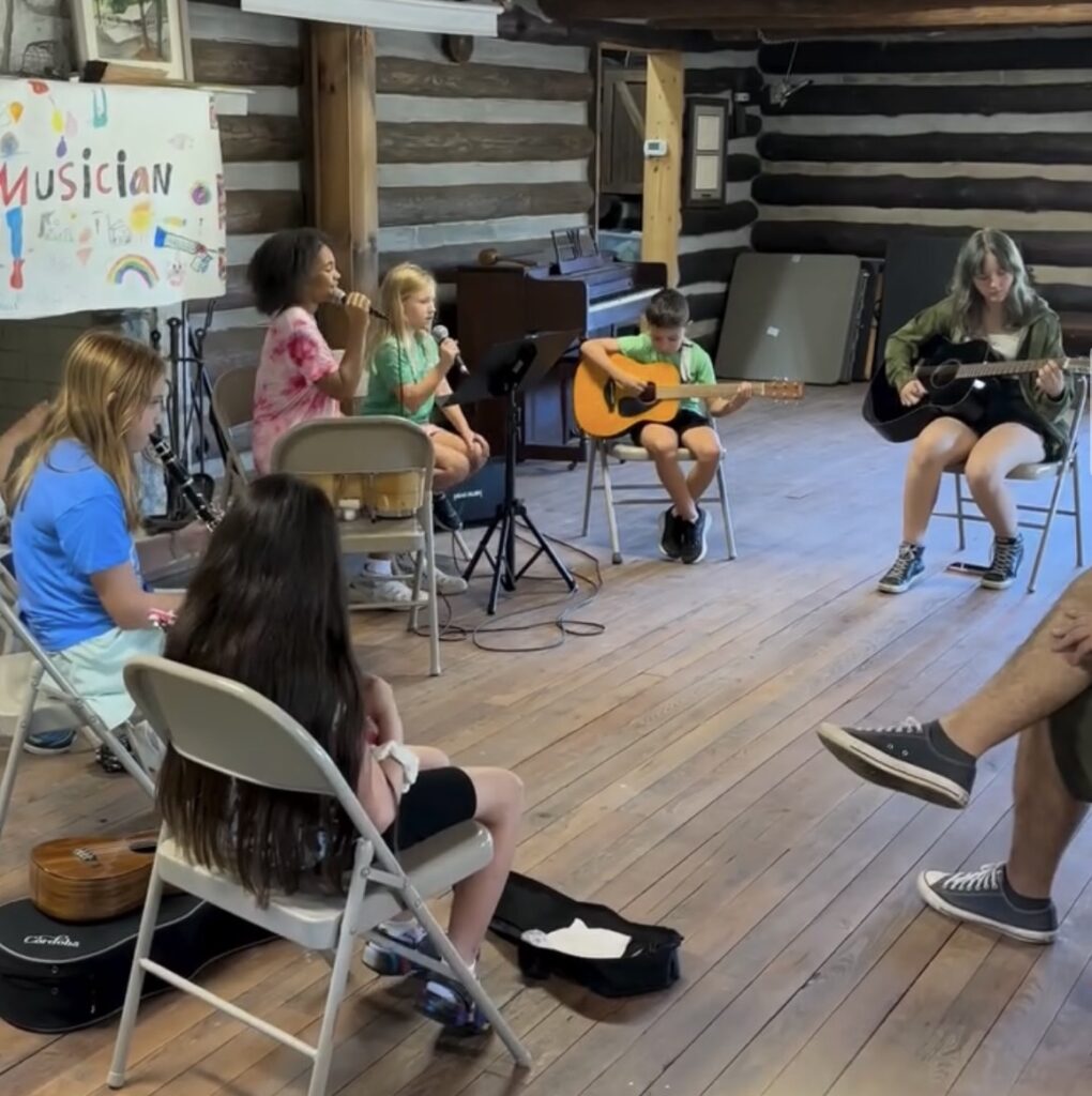 scene from last year's Acoustic Jam Fest - kids sitting in a circle playing their instruments