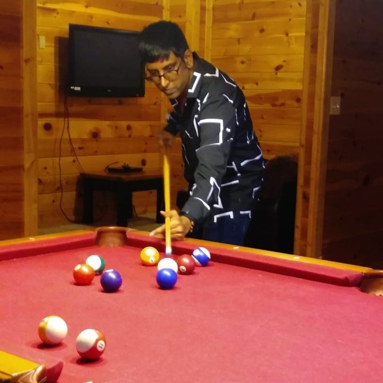 Joseph Satralkar playing pool